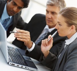 Team of business people working together on a laptop